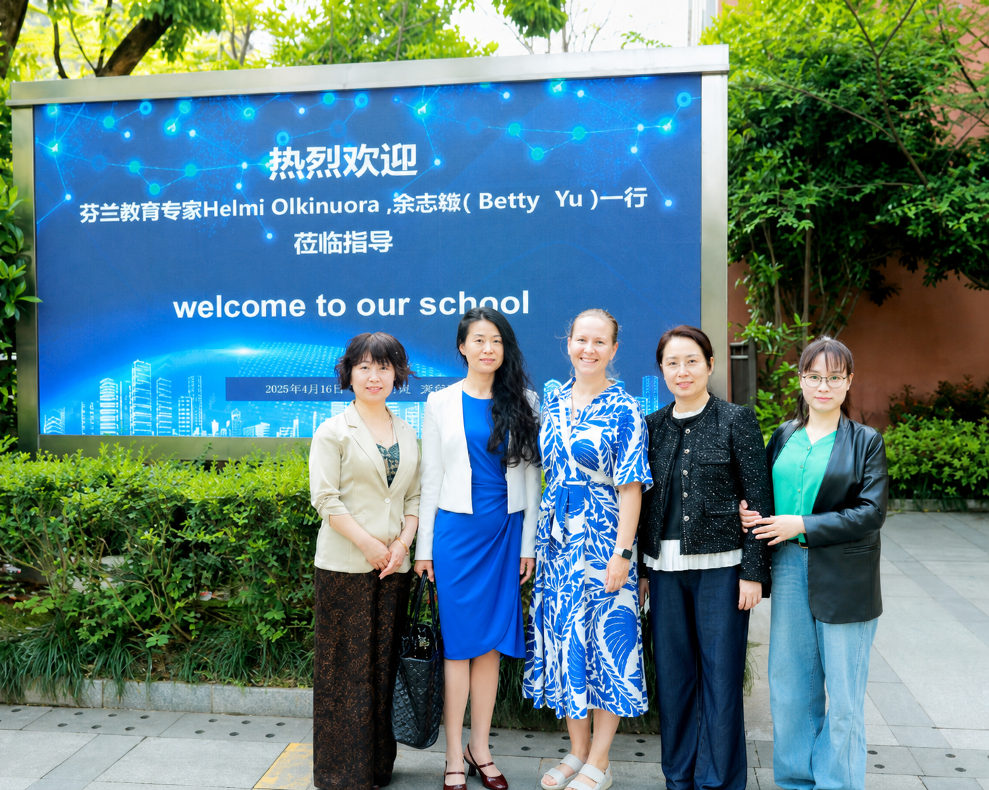 Finnish and Chinese education representatives outside a school